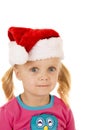 Wide eyed blond girl portriat wearing santa hat