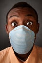 Wide-eyed man in surgical mask Royalty Free Stock Photo
