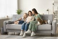 Wide family home portrait of three female generations with dog Royalty Free Stock Photo