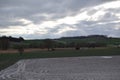 snow on the fields with green grassland