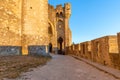 Wide fortified walls with walkways and arches of medieval castle of Carcassonne town at sunset Royalty Free Stock Photo