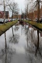 Wide front view on a sailor ship and its reflection at the canal and the surrounding in papenburg germany