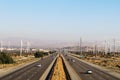 A wide full angle view overlooking multiple lanes of california freeway interstate highway traffic with desert and blue sky Royalty Free Stock Photo