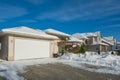 Wide garage of luxury house with driveway and front yard in snow Royalty Free Stock Photo