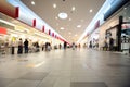 Wide hall and buyers in trading centre with shops Royalty Free Stock Photo