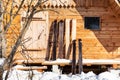 Wide hunter skis in front of wooden cottage