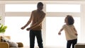 Wide image african dad and daughter dancing having fun indoors Royalty Free Stock Photo