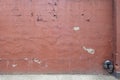 Distant image of weathered and distresed painted concrete wall with chips of paint and cracks