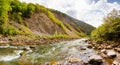 Wide landscape photo of autumn forest river with rocks and mountains Royalty Free Stock Photo