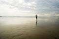 Wide lens silhouette of African American runner woman jogging on the beach - young attractive and athletic black girl training Royalty Free Stock Photo