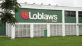 wide medium shot of loblaws great food logo on store with grass lawn in front