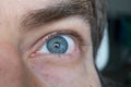 Wide open Caucasian male eye. Close up shot portrait, unrecognizable face Royalty Free Stock Photo