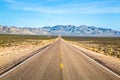 Wide open road and distant mountains in wide open Nevada desert along the Extraterrestrial Highway