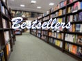 Wide out of focus view of the inside of a bookstore with the word Bestsellers in the foreground