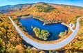 Wide panorama aerial over highway through stunning peak fall foliage New Hampshire mountains around blue lake Royalty Free Stock Photo