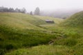 Wide panorama of beautiful foggy meadow. Dense fog over a stream in a meadow and trees silhouettes at early autumn morning Royalty Free Stock Photo