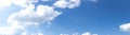 Wide panorama of brilliant blue sky with white clouds, creative copy space, atmosphere and weather Royalty Free Stock Photo