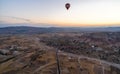 Wide panorama of Cappadocia landscape - colored balloons flying over mountain peaks and fantastic valley. Air balloons above