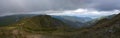 Wide panorama of grassy green hills and slopes at ridge of Low Tatras mountains with hiking trail footpath, mountain Royalty Free Stock Photo