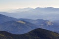 Wide panorama of green mountain hills in sunny clear weather. Carpathian mountains landscape in summer. View of rocky peaks covere Royalty Free Stock Photo