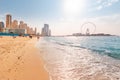 Wide panorama of Persian Gulf with famous Ferris wheel Dubai Eye and numerous skyscrapers with hotels and residences and sandy