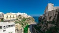 Wide panorama of Polignano a mare, a beautiful city in Puglia, italy, on a sunny day. Visible beach coming to the sea, looking Royalty Free Stock Photo