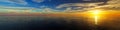 Wide panorama view of sunset or sunrise of open ocean or sea with blue sky and light clouds Royalty Free Stock Photo