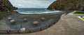 Wide panorama. Volcanic black sand. Beach umbrellas and a children`s pool. Vacation spot for locals and tourists. Castillo del Ma Royalty Free Stock Photo