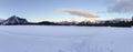 Snowshoeing across frozen snow covered Mountain Lake Landscape in Canadian Rockies, Alberta