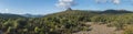 Wide panoramic landscape with View of limestone mountain Monte Oseli, green forest, trees and hills in region Ogliastra