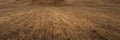 Wide panoramic view of arable land with long rows of furrows. autumn or spring hilly cultivated agricultural field. Artistic