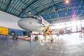 Wide panoramic view of aviation hangars and aircraft on maintenance, with bright lights outside the gate Royalty Free Stock Photo