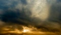 a wide panoramic view of the dramatic sky with thick clouds and an orange glow from sunlight. vibrant artistic backdrop for Royalty Free Stock Photo