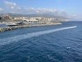 wide panoramic view of the harbor of Genoa. Blue sky blue sea white clouds and port buildings in harmony with the Royalty Free Stock Photo