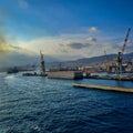 wide panoramic view of the harbor of Genoa. Blue sky blue sea white clouds and port buildings in harmony with the