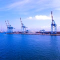 wide panoramic view of the harbor of Genoa. Blue sky blue sea white clouds and port buildings in harmony with the Royalty Free Stock Photo