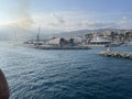 wide panoramic view of the harbor of Genoa. Blue sky blue sea white clouds and port buildings in harmony with the Royalty Free Stock Photo