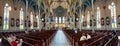 A wide panoramic view of the interior of the Historic Cathedral Basilica of St. John the Baptist in Savannah, Georgia