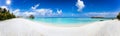 Wide panoramic view of a tropical beach with turquoise sea, Palm trees and water lodges Royalty Free Stock Photo