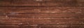 Wide panoramic wooden scratched textured background of old long horizontal planks with peeling brown paint and nails. artistic