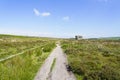 Wide path leads past the Eagle Stone gritstone outcrop Royalty Free Stock Photo