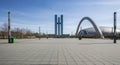 Wide plaza in front of modern architectural buildings with a large arched structure square modern architecture Royalty Free Stock Photo