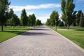 wide, paved walking path in a park