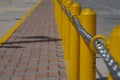 Chain along a yellow post line on a street Royalty Free Stock Photo