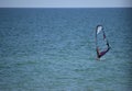 Wide photo of professional wind surfer practice on the sea wave with deep blue open turquoise sea. Azov sea Royalty Free Stock Photo