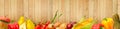 Wide photo ripe vegetables and fruits on background of wooden wall Royalty Free Stock Photo