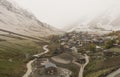 A wide photo of a vintage village in Mestia, Georgia, shows the village on a hill.