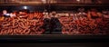 Wide photography of butcher shop and its fridged counter with meat