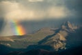 Wide Rainbow Falls from Storm Cloud over Mountains in Rocky Mountain National Park Royalty Free Stock Photo