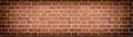 Wide red brick wall texture. Rough brickwork widescreen backdrop. Large long abstract background